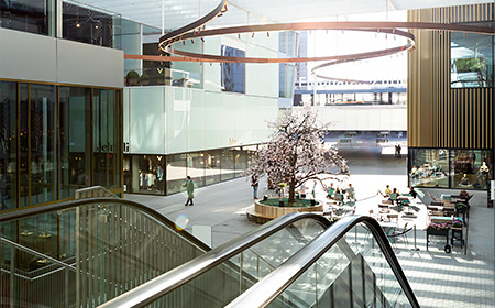 shopping centre with retail stores and escalator