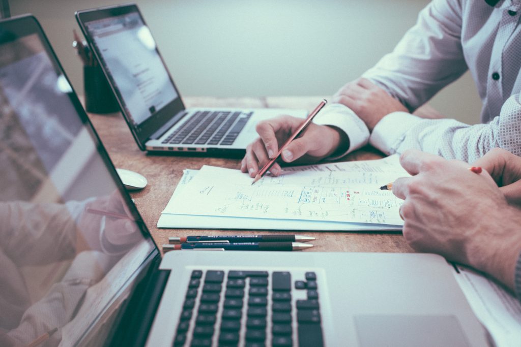 two accountants on a laptop calculating the gst on a commercial property lease